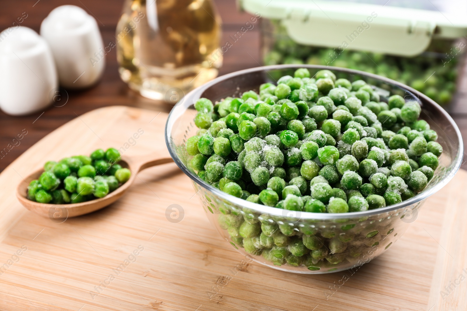 Photo of Frozen green peas on wooden table, closeup. Vegetable preservation