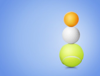 Stack of different sport balls on pale blue background, space for text