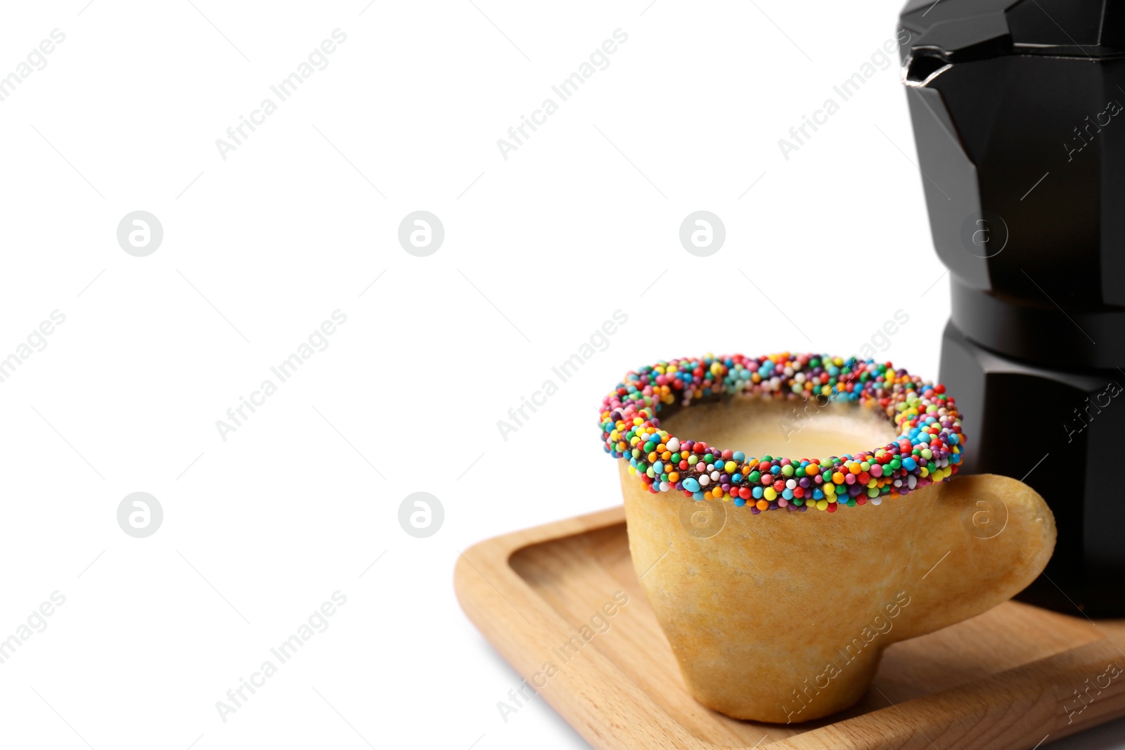 Photo of Delicious edible biscuit cup decorated with sprinkles on white background, space for text