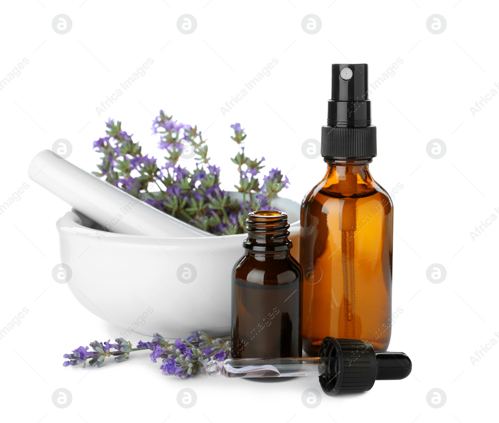 Photo of Bottles of essential oil, mortar and pestle with lavender flowers isolated on white