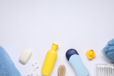 Different baby bath accessories and cosmetic products on white background, flat lay. Space for text