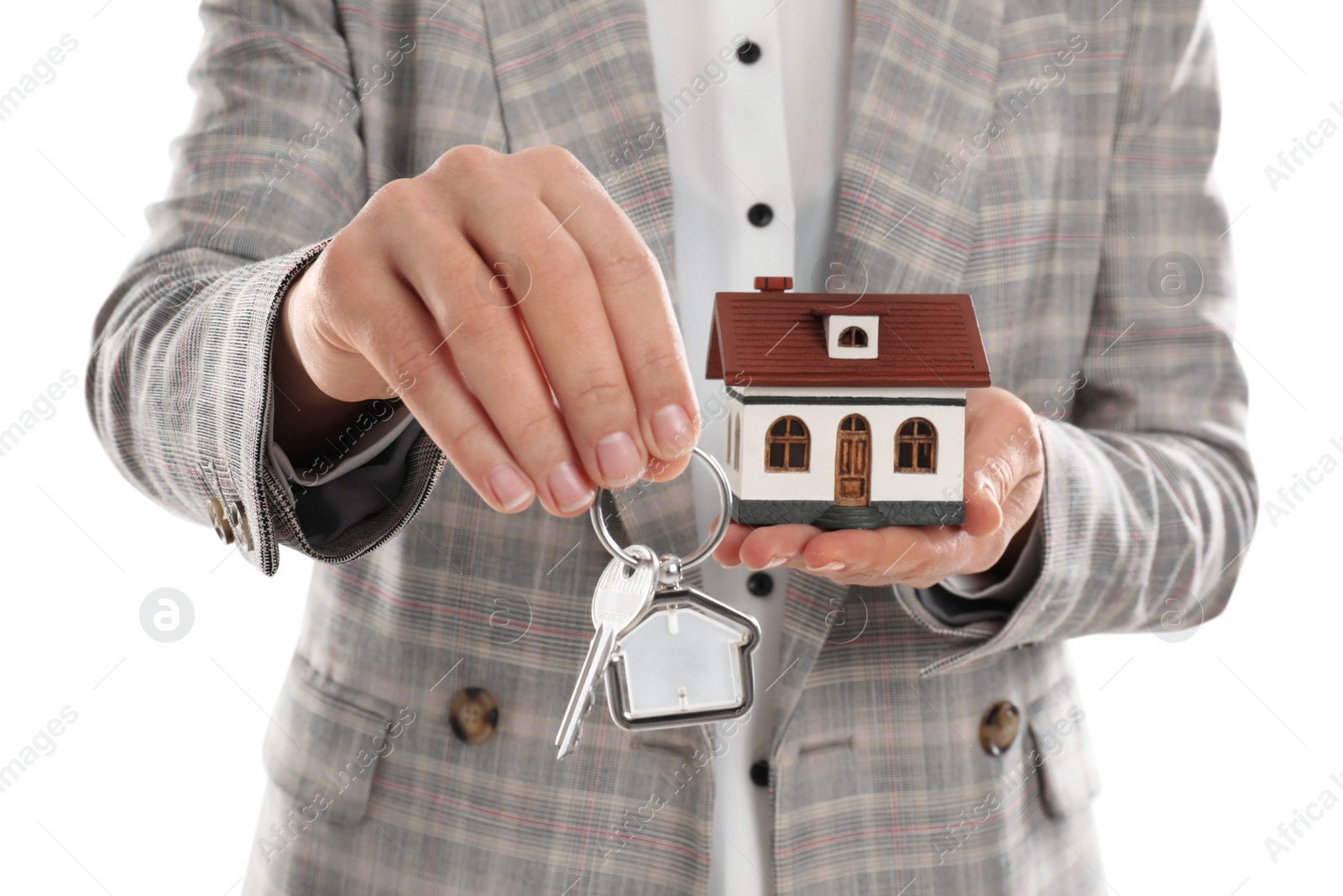 Photo of Real estate agent holding house model and key on white background, closeup