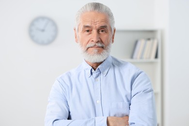 Photo of Portrait of handsome senior man in office