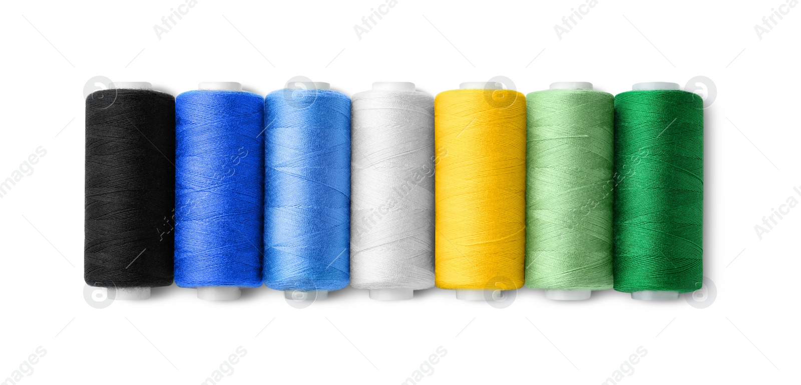 Photo of Set of different colorful sewing threads on white background, top view