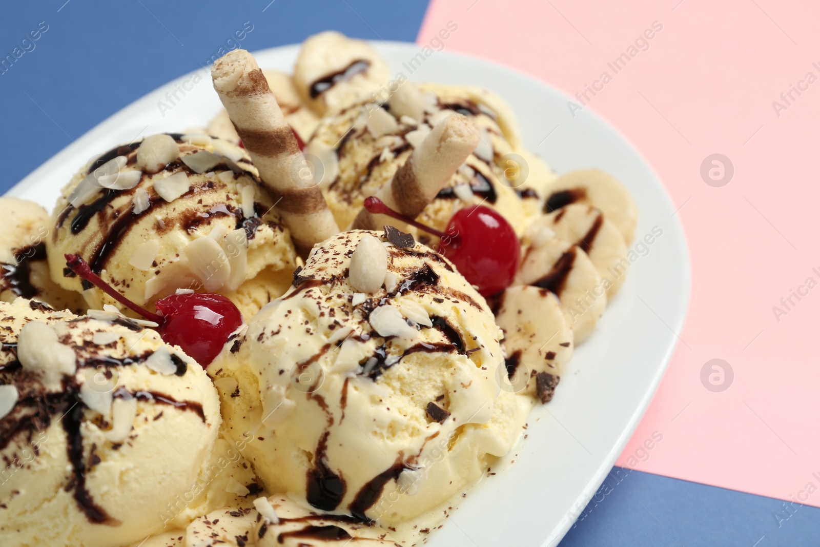 Photo of Delicious dessert with banana ice cream on color background, closeup