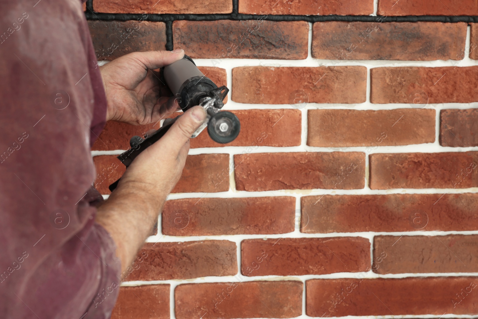 Photo of Professional builder using tiling fugue for grouting, closeup