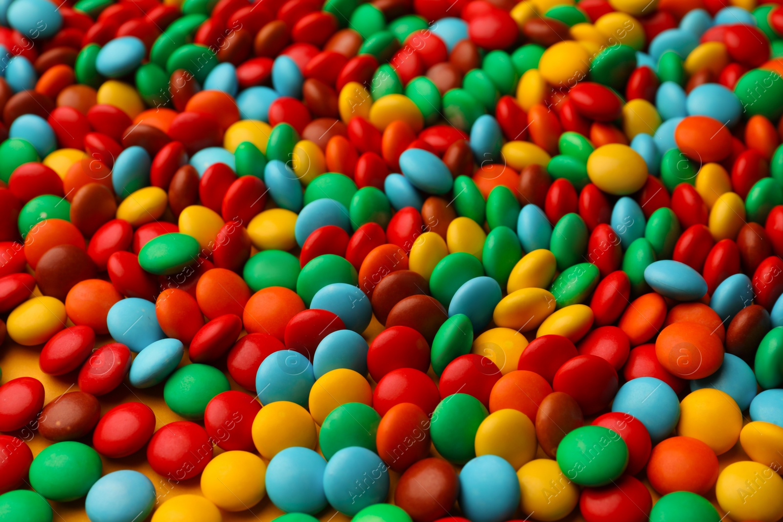 Photo of Tasty colorful candies as background, closeup view