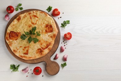 Photo of Delicious khachapuri with cheese on white wooden table, flat lay. Space for text