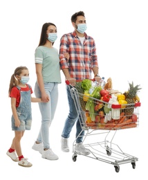 Photo of Family in medical masks with shopping cart full of groceries on white background