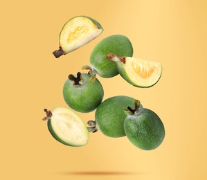 Image of Fresh feijoa fruits falling on orange background