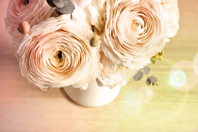 Image of Beautiful spring ranunculus flowers in vase on wooden background, closeup