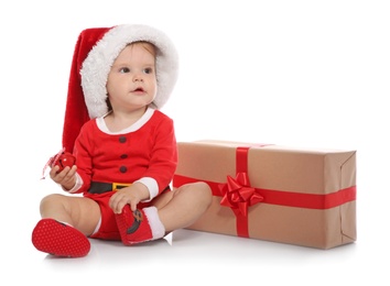 Photo of Cute little baby in Christmas costume and gift on white background