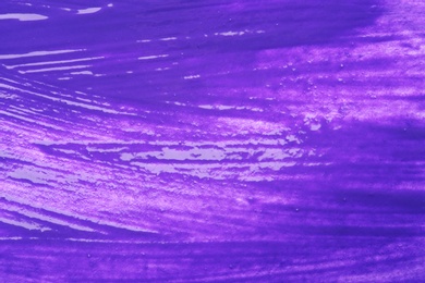Photo of Abstract brushstrokes of bright violet paint as background