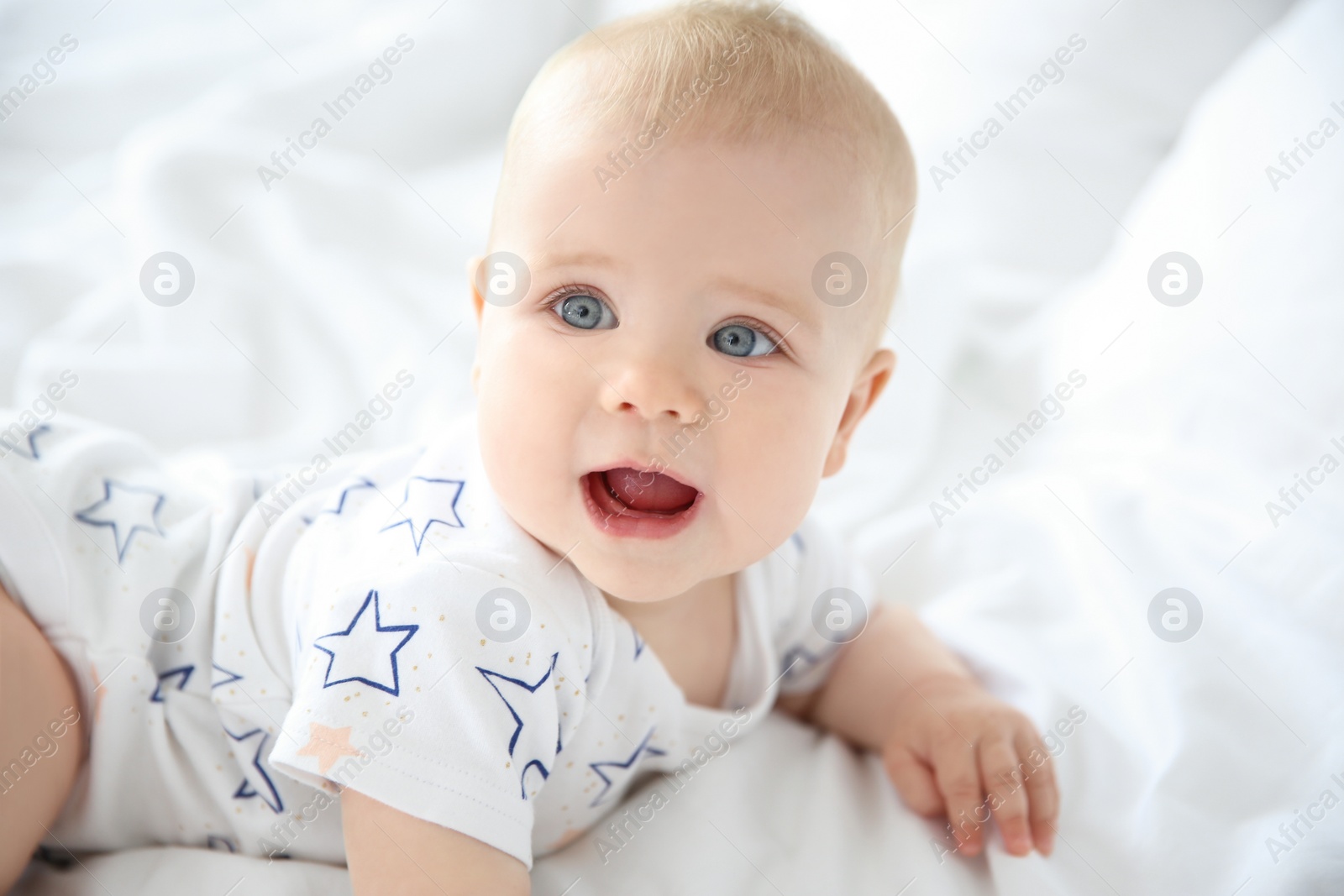 Photo of Cute little baby on bed at home