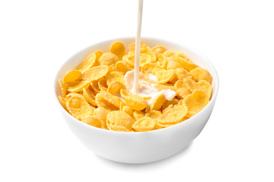 Photo of Pouring milk into bowl with corn flakes on white background