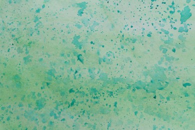 Photo of Abstract watercolor painting with green blots as background, top view