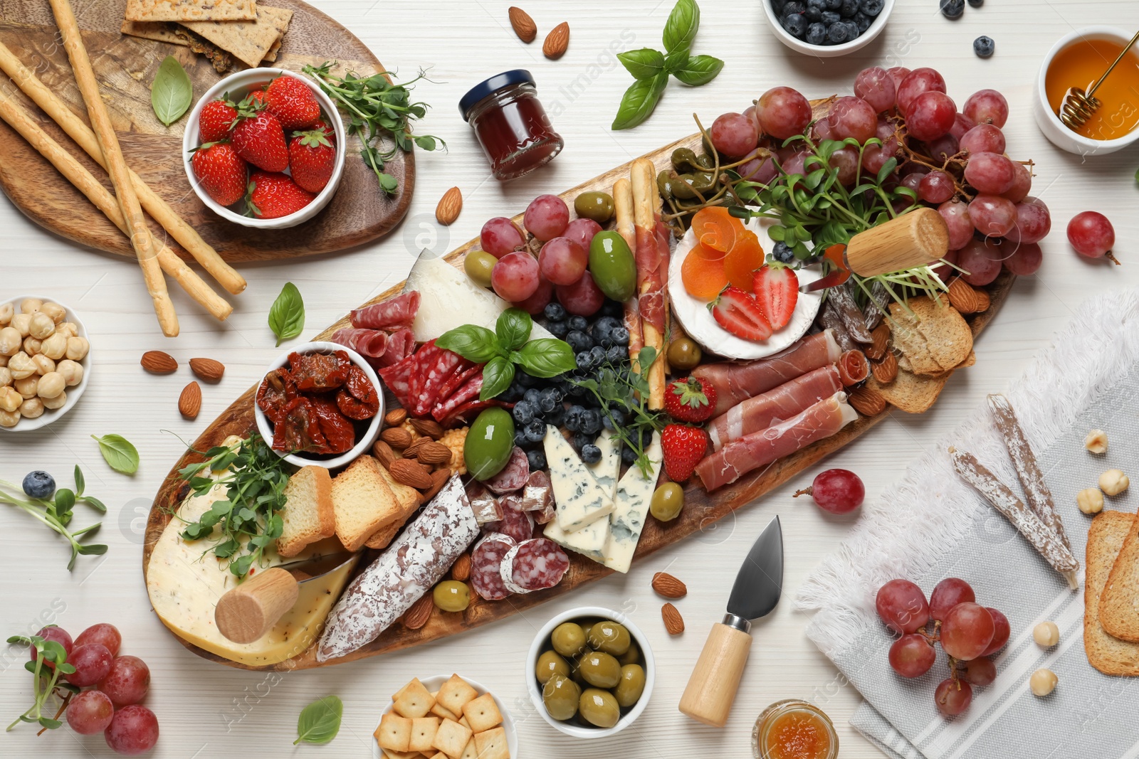 Photo of Set of different delicious appetizers served on white wooden table, flat lay