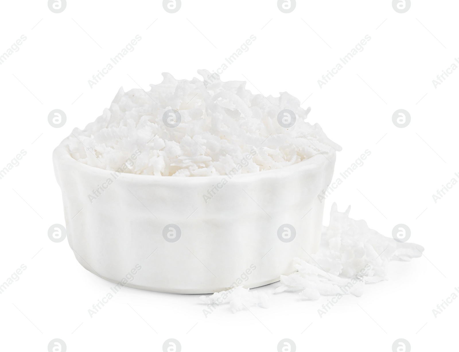 Photo of Coconut flakes in bowl isolated on white