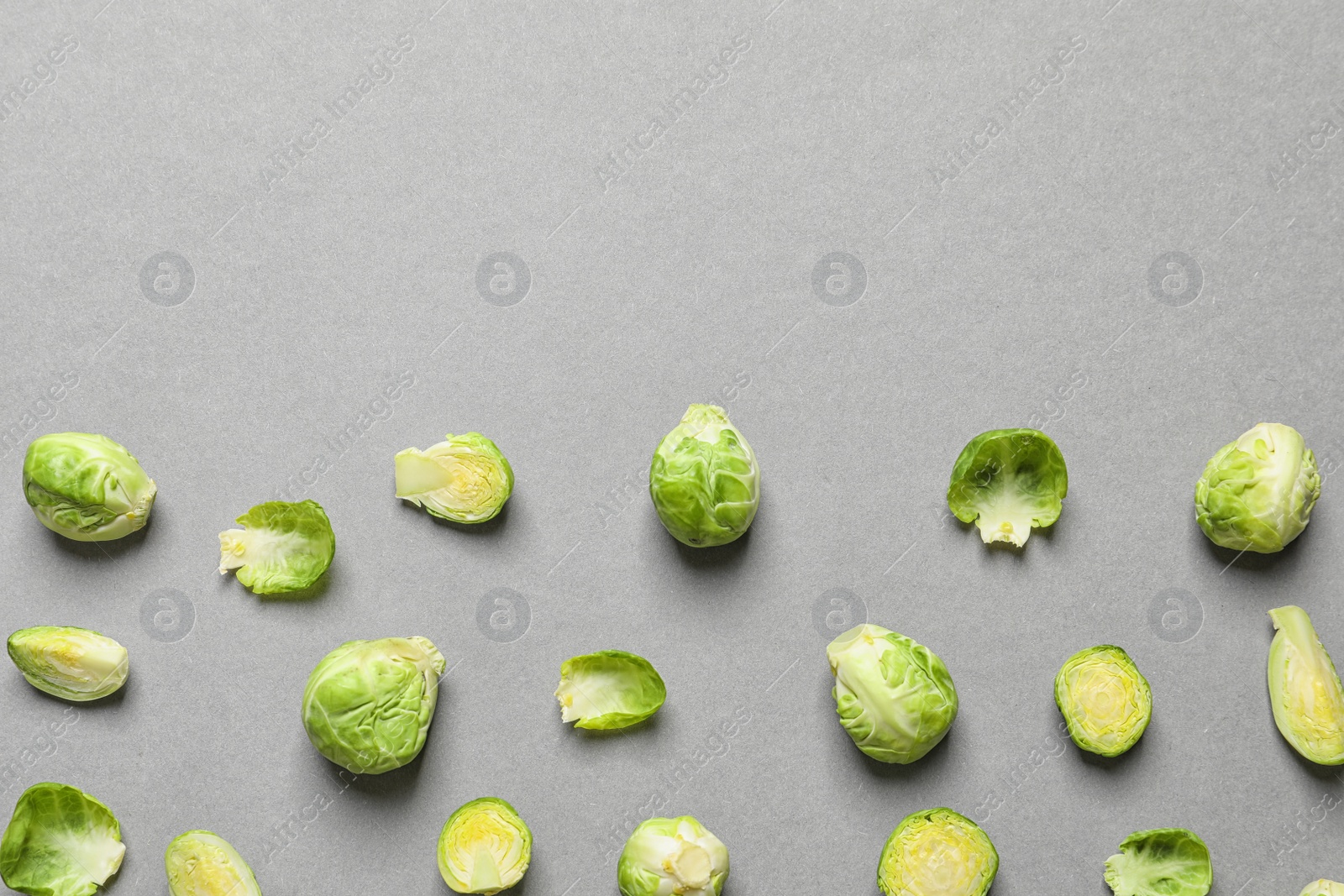 Photo of Tasty fresh Brussels sprouts on grey background, top view with space for text