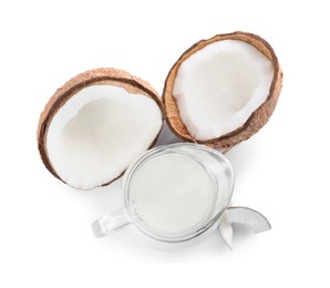 Photo of Glass jug of delicious vegan milk and coconuts on white background, top view