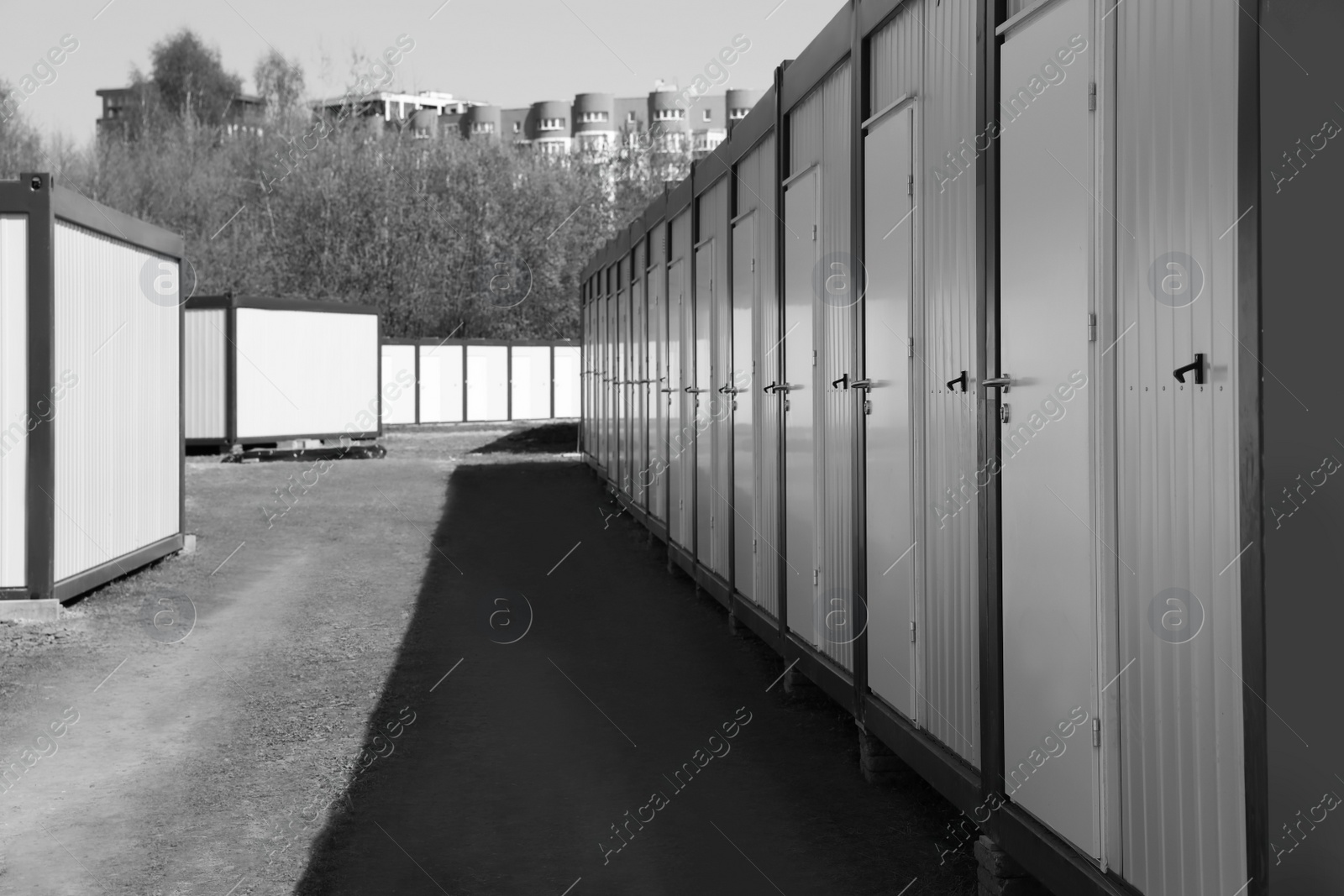 Photo of New modular houses for internally displaced persons outdoors. Black and white effect