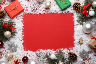 Photo of Frame made of Christmas decorations on red background, top view with space for text. Winter season