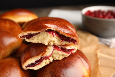 Baked cranberry pirozhki, closeup view. Delicious pastry
