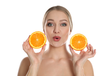 Photo of Young woman with cut orange on white background. Vitamin rich food