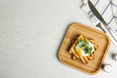 Photo of Delicious poached egg with toasted bread and sprouts served on white wooden table, flat lay. Space for text