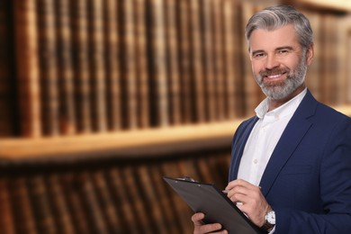 Lawyer with clipboard near shelves with books, space for text