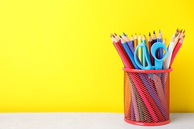 Photo of Different school stationery on white table against yellow background, space for text. Back to school