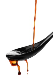 Photo of Pouring soy sauce into spoon against white background