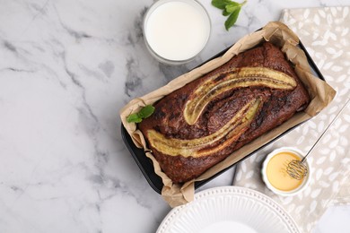 Delicious banana bread served on white marble table, flat lay. Space for text