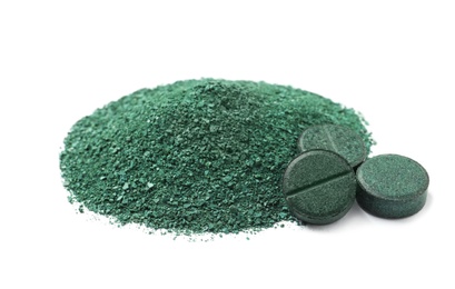 Photo of Pile of spirulina powder and pills on white background