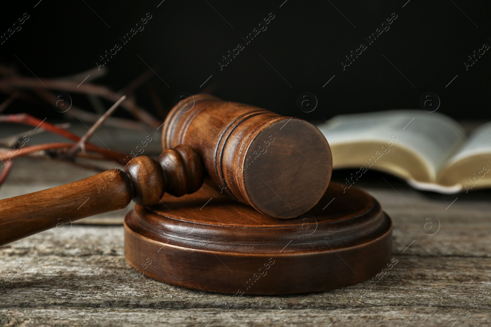 Photo of Judge gavel on old wooden table, closeup
