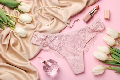 Photo of Flat lay composition with women's underwear and perfume on pink background