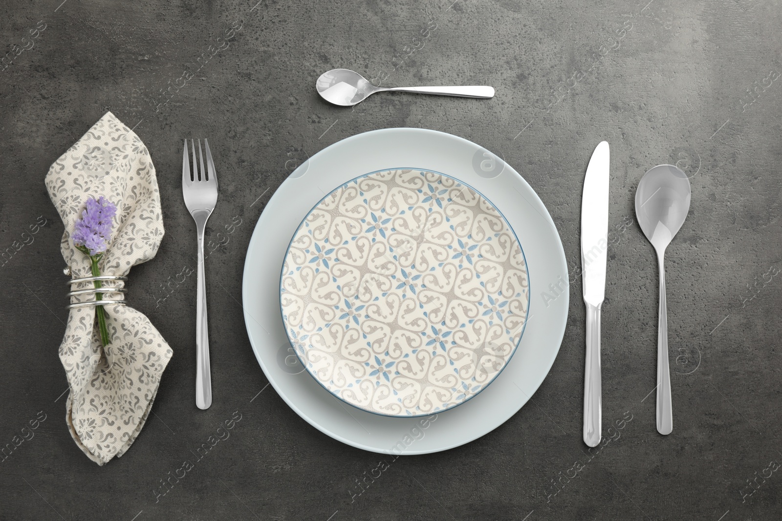 Photo of Stylish setting with cutlery and plates on black table, flat lay