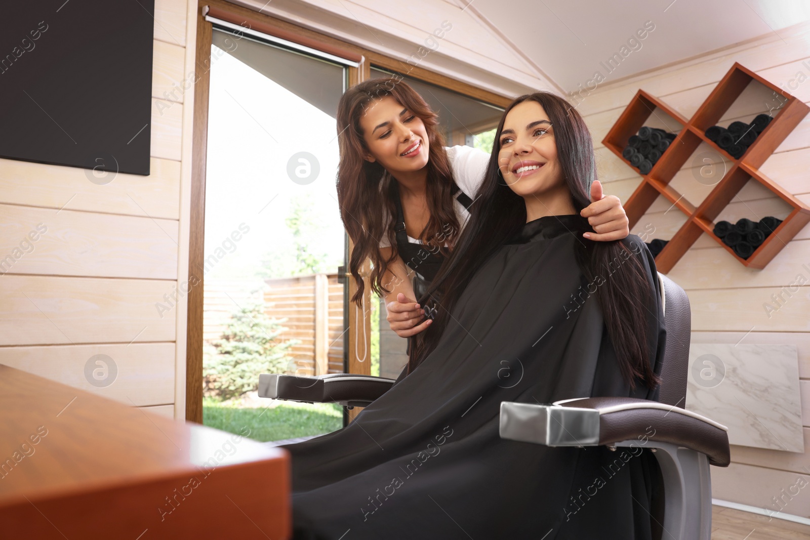 Photo of Hairdresser working with client in beauty salon