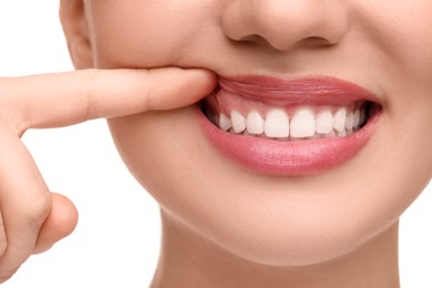 Woman showing her clean teeth on white background, closeup