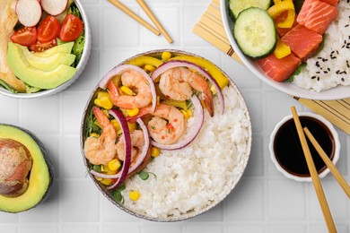 Set of delicious poke bowls with different ingredients on white table, flat lay