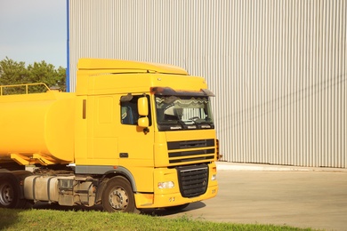 Photo of Modern yellow truck on country road. Space for text