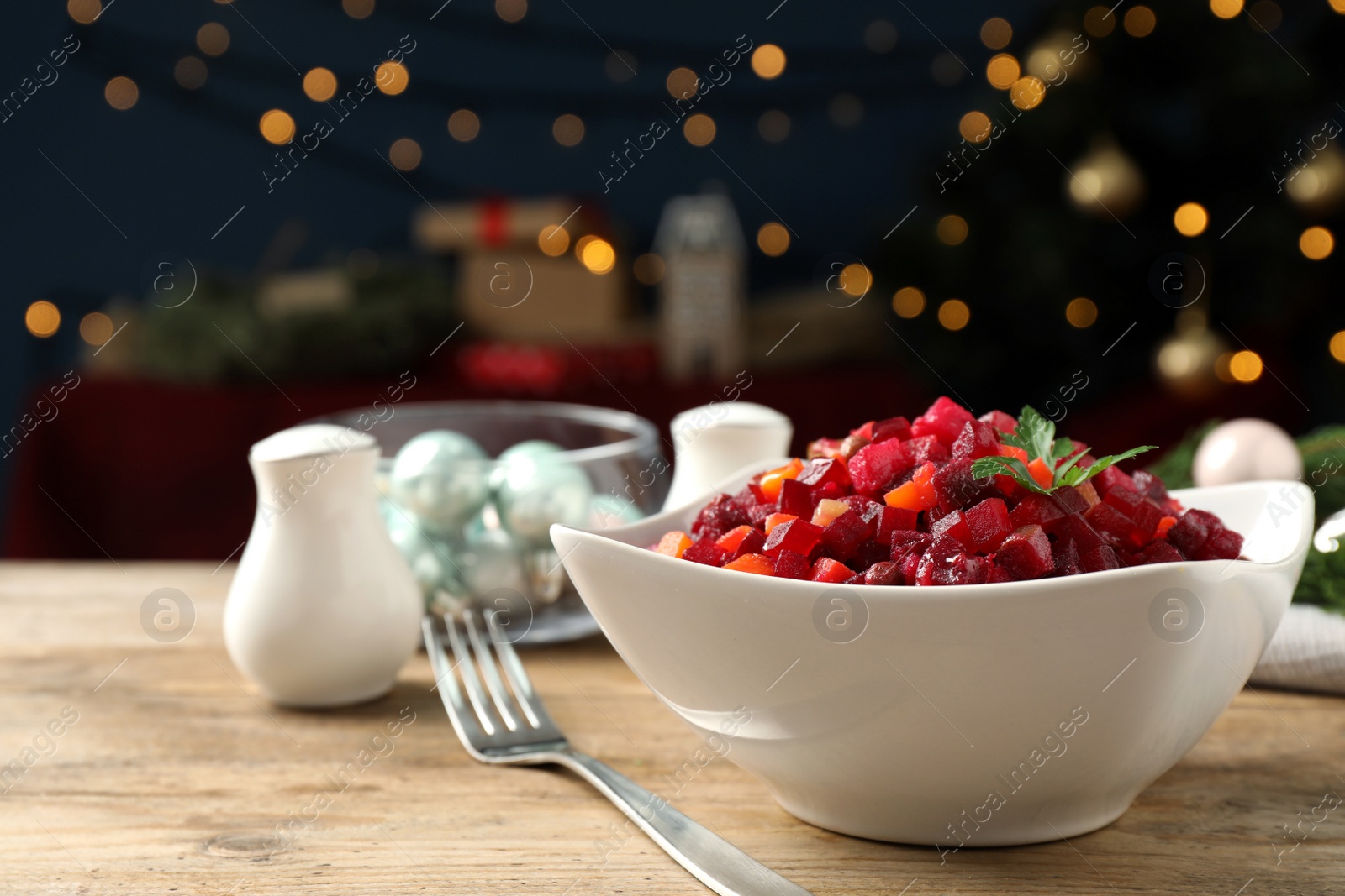 Photo of Traditional Russian salad vinaigrette served on wooden table. Space for text