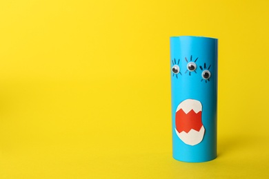 Funny blue monster on yellow background, space for text. Halloween decoration