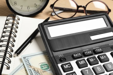 Photo of Calculator, money and stationery on table, closeup. Tax accounting