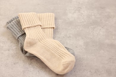 Soft comfortable socks on grey table, closeup. Space for text