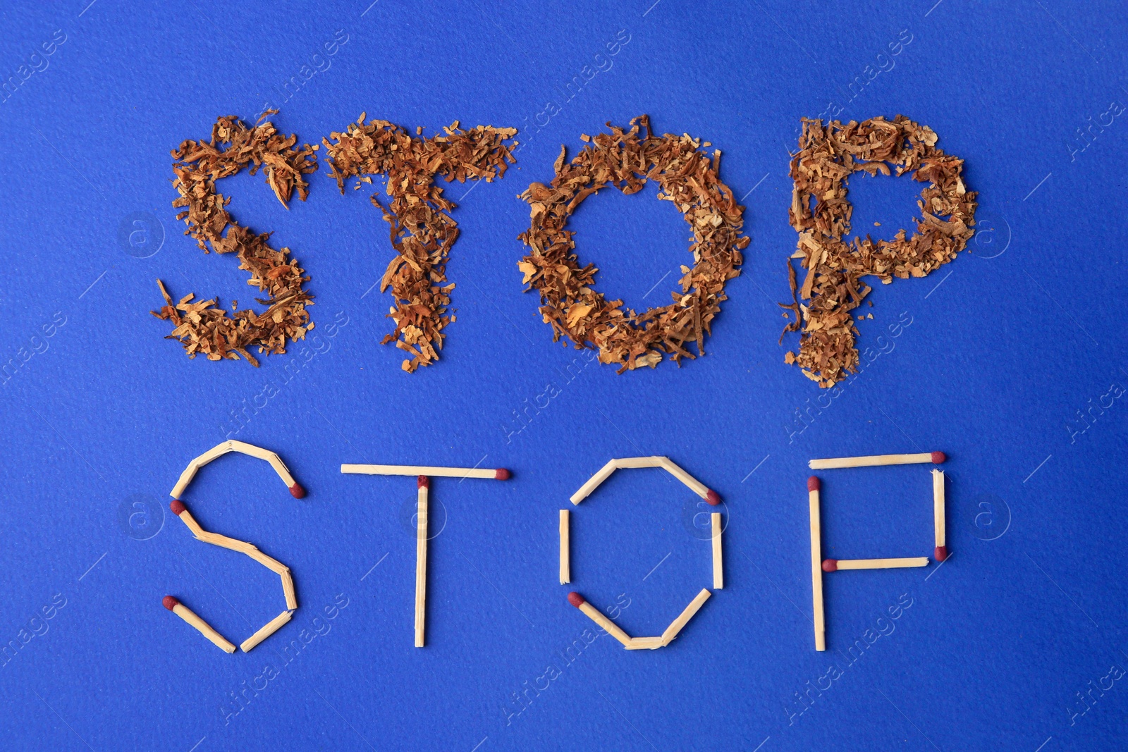 Photo of Words Stop made of dry tobacco and matches on blue background, flat lay. Quitting smoking concept