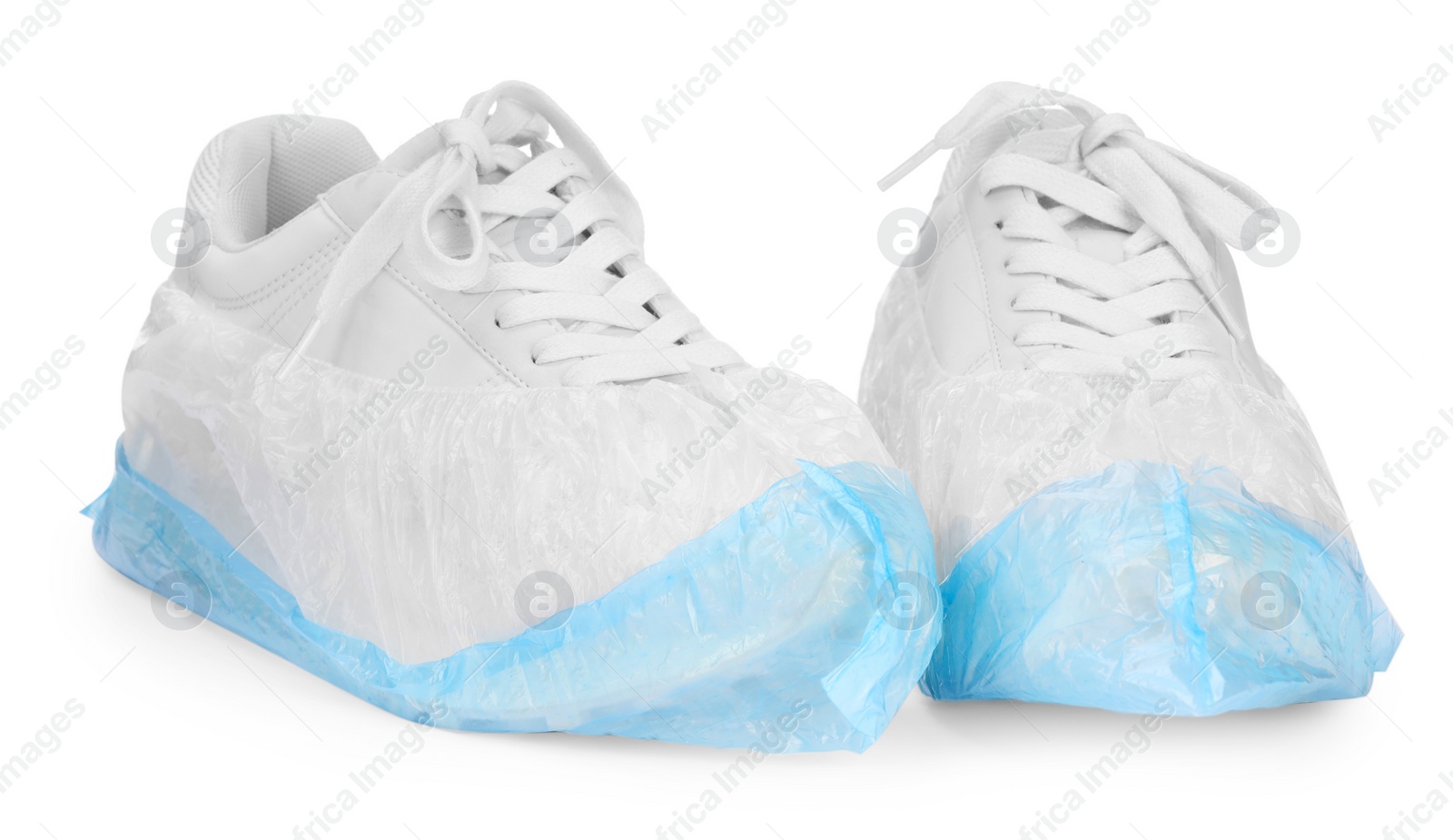 Photo of Sneakers in shoe covers isolated on white