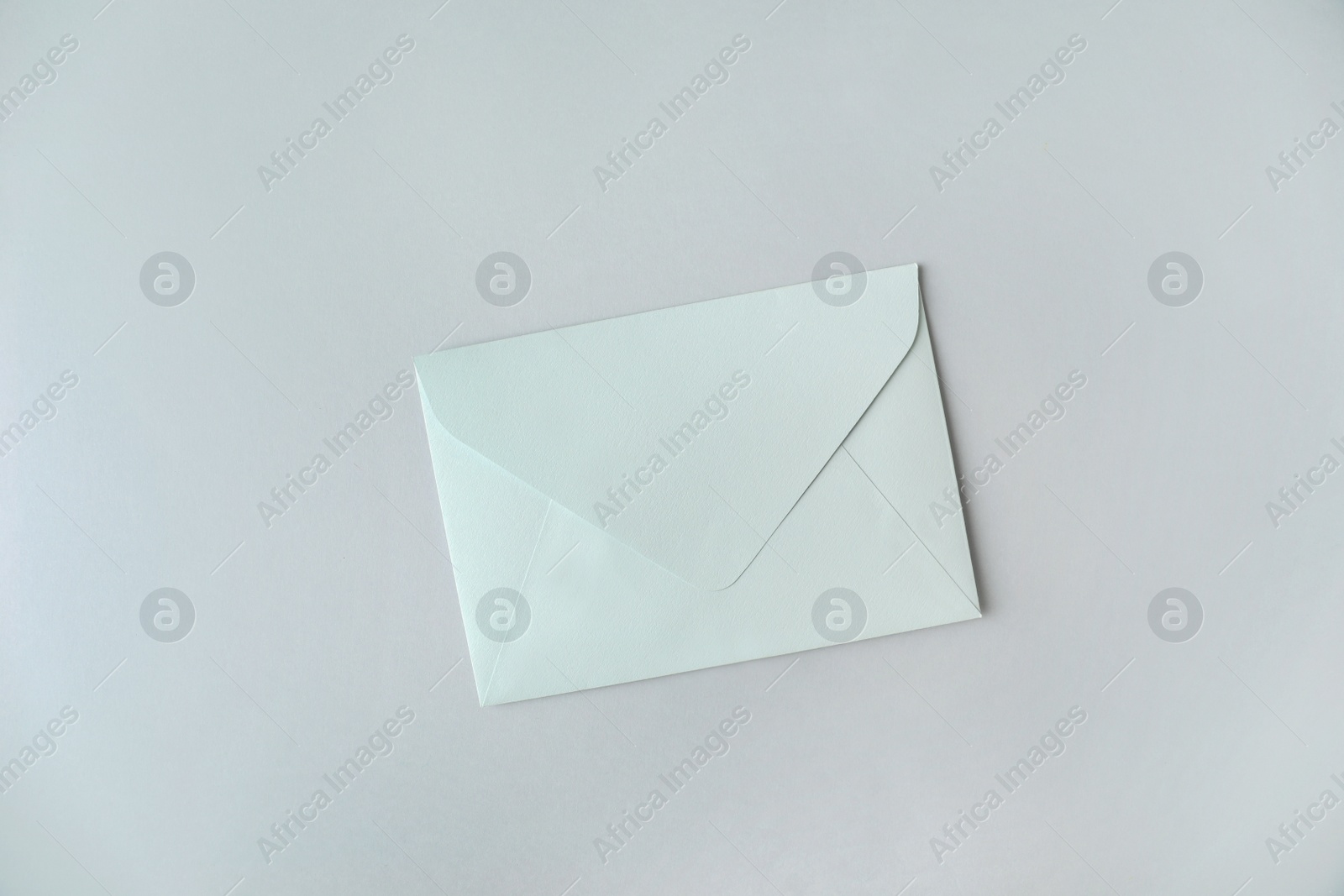 Photo of Paper envelope on light grey background, top view