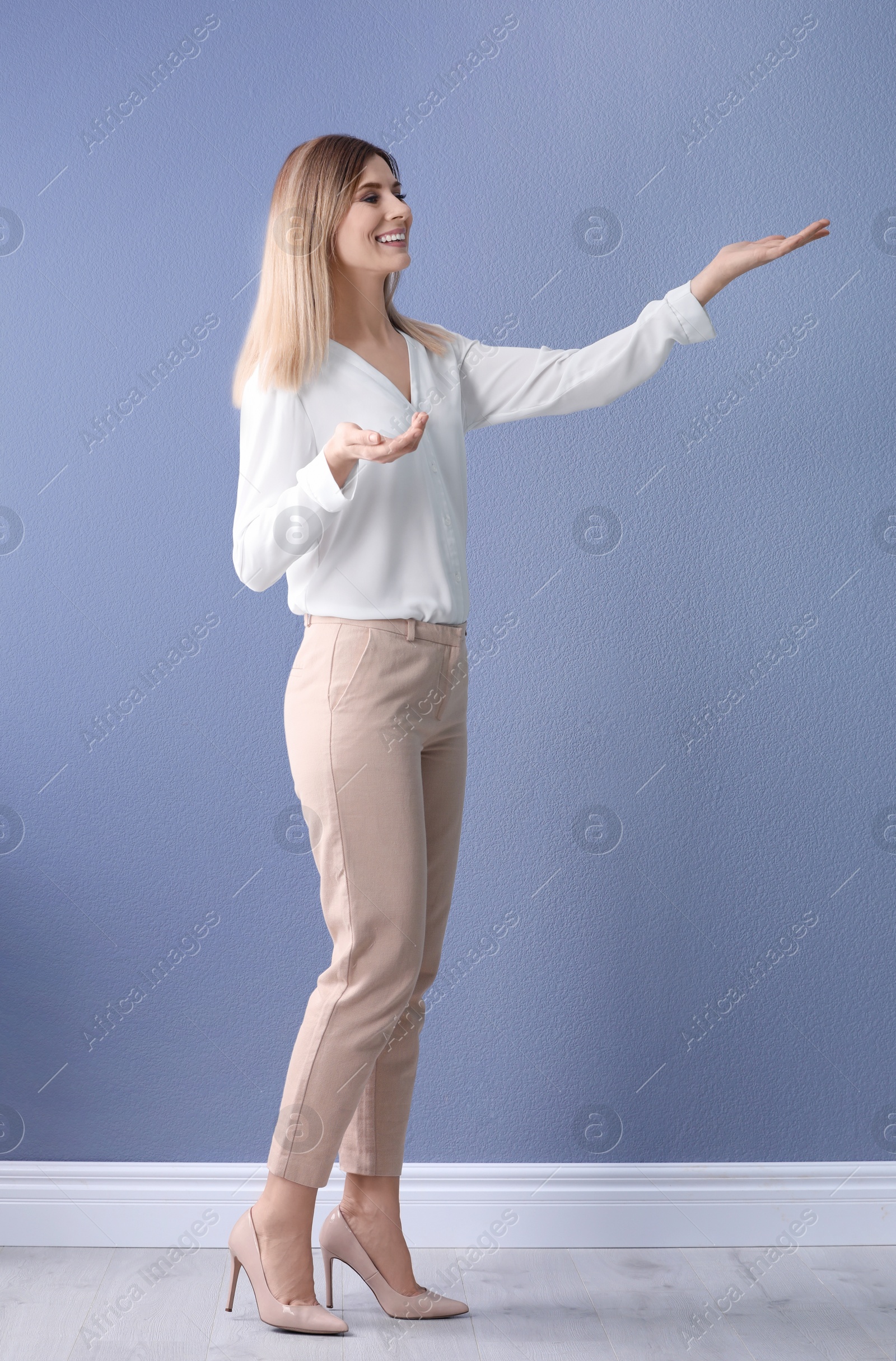 Photo of Female business trainer on near color wall