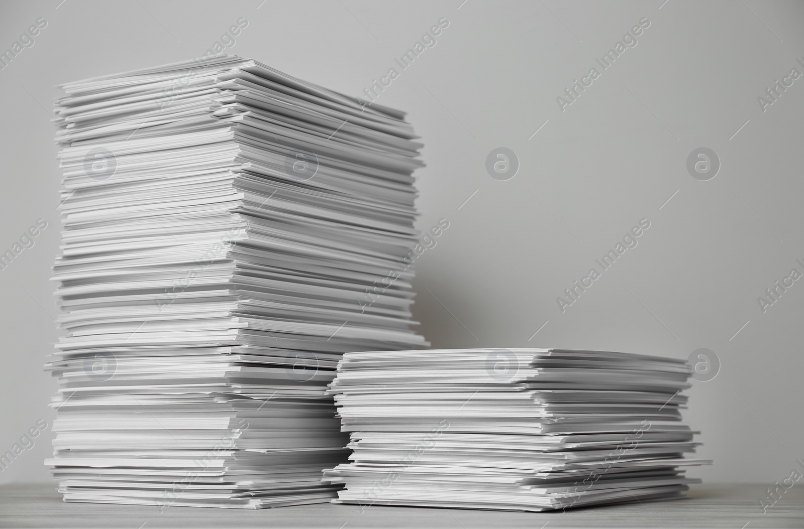 Photo of Stacks of paper sheets on wooden table